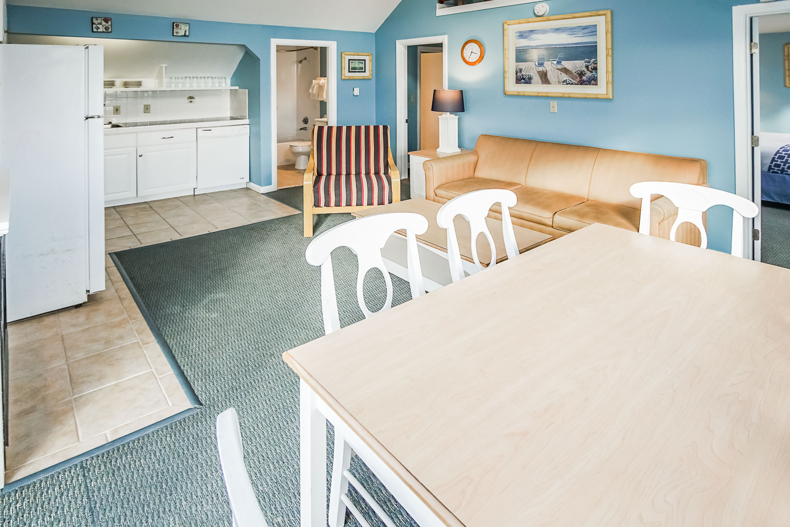 A cozy living and dining room area, equipped with a kitchenette at VRI's Seawinds II Resort in Massachusetts.